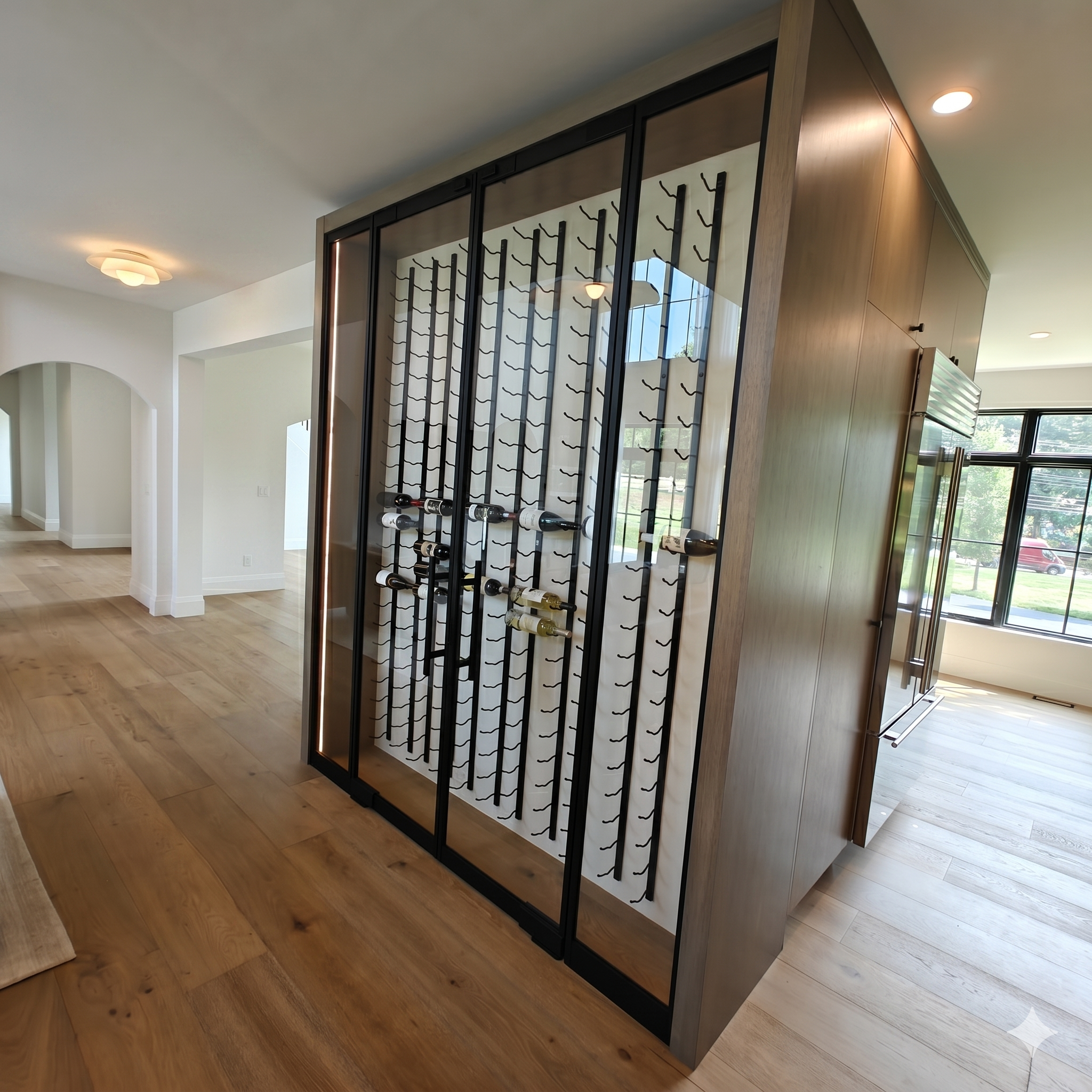 Custom glass wine display cabinet with anodized aluminum frame — WiseGlass NY residential installation