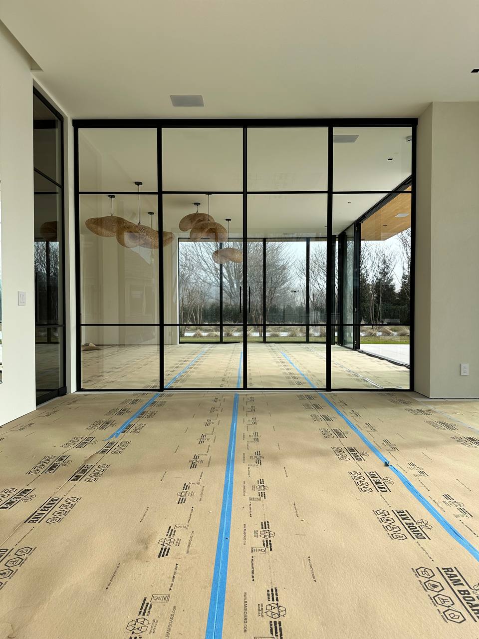 Completed double-sliding black matte aluminum-framed glass partition, Water Mill NY estate — WiseGlass NY