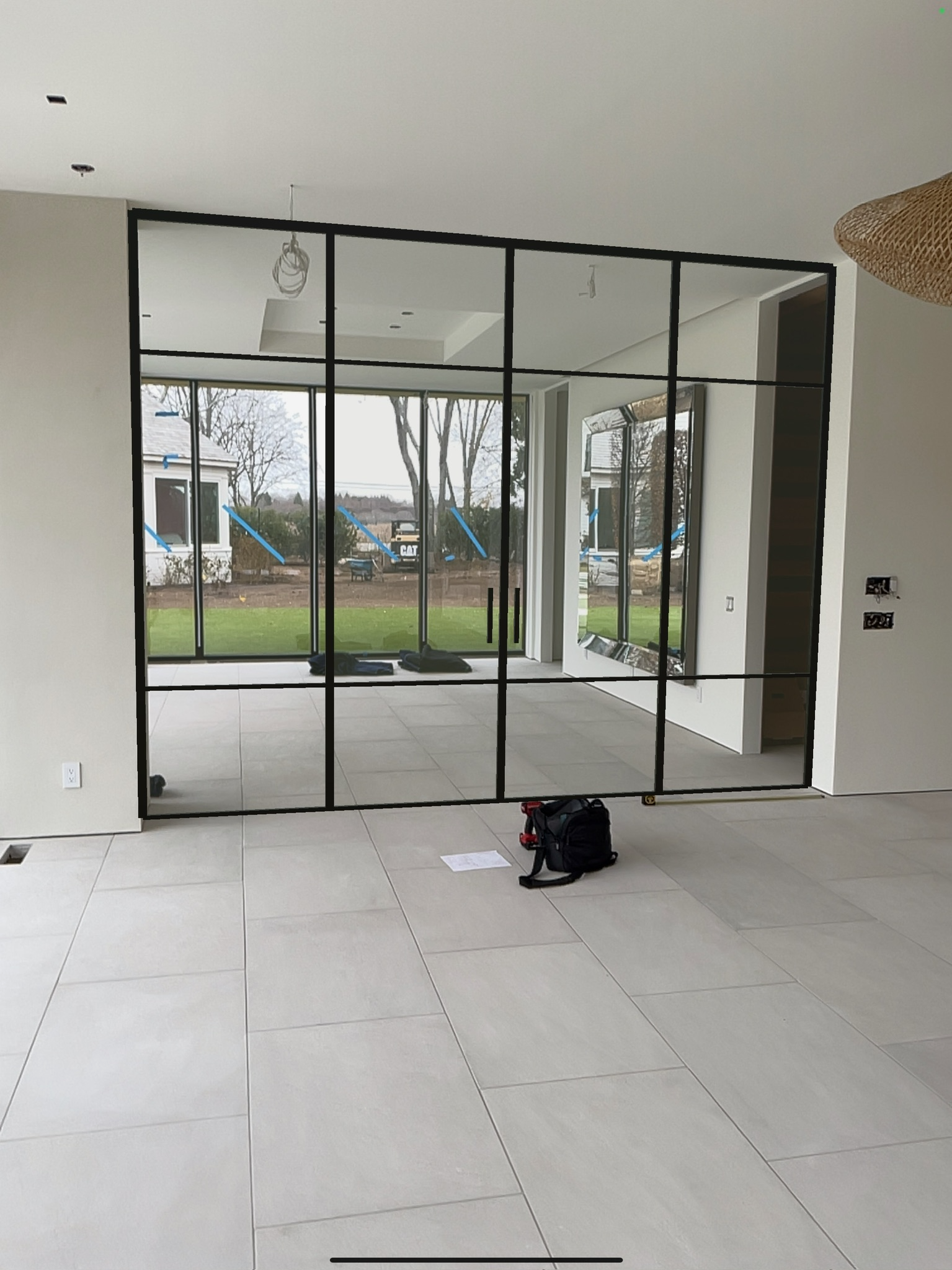 Onsite consultation at Water Mill NY estate — measuring the raw opening before WiseGlass NY custom glass partition production