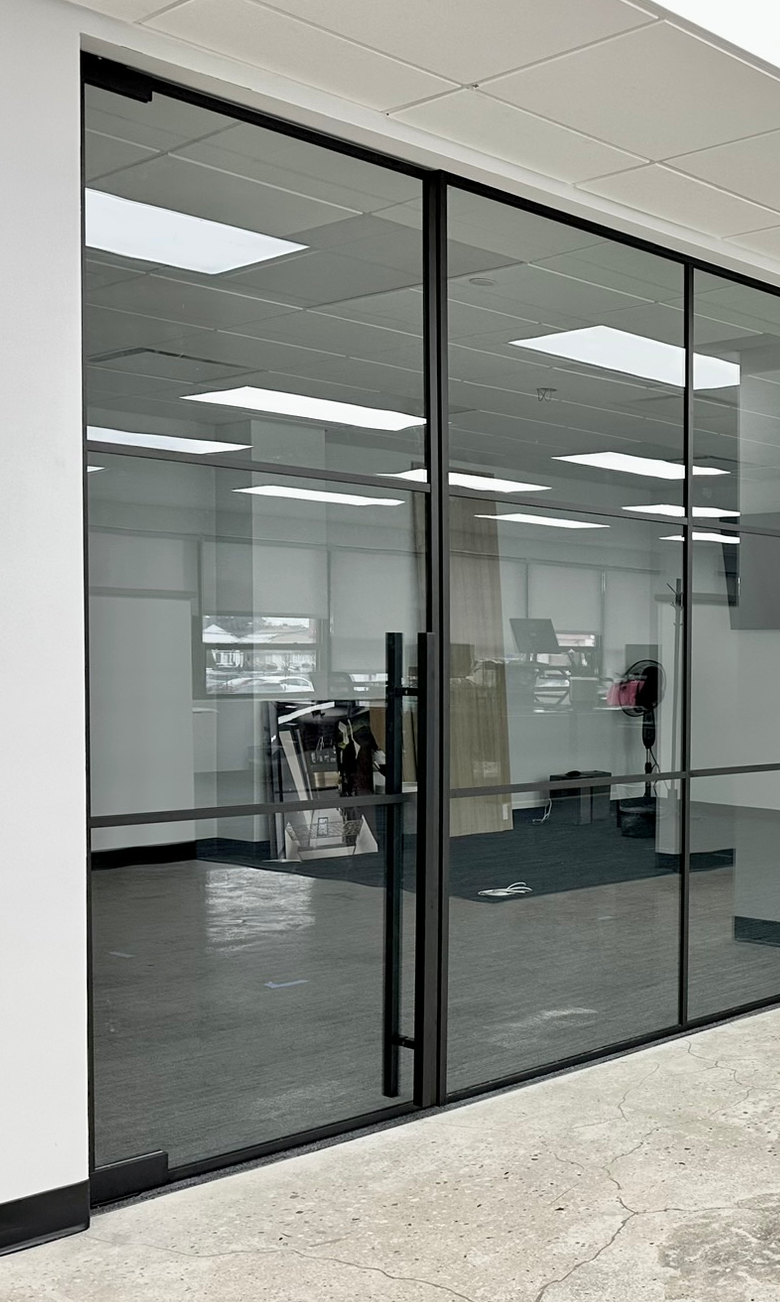 48-inch commercial bar door handle on black matte glass partition — WiseGlass NY, Rosedale NY