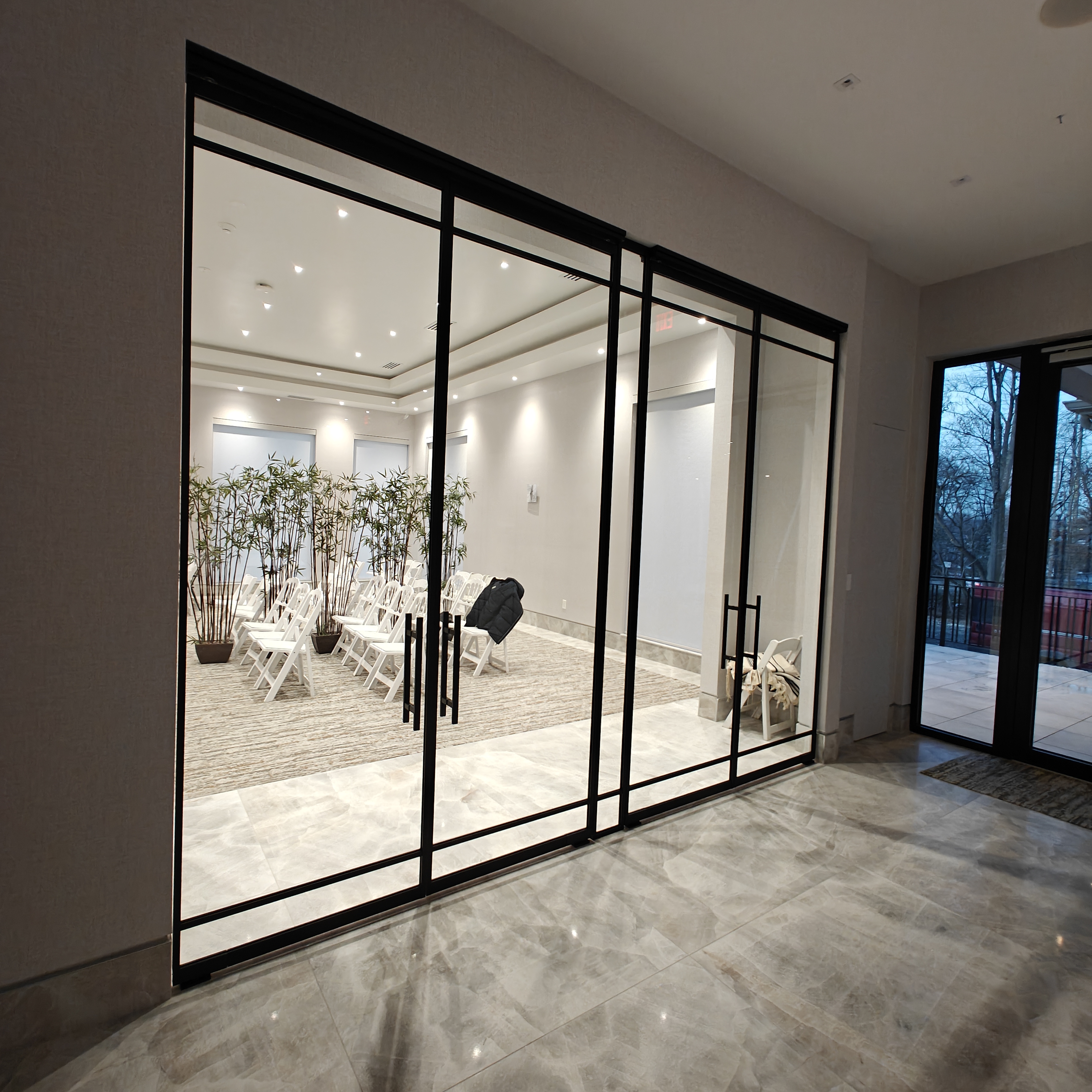 Custom tall black matte French doors with center sidelight for synagogue entrance — WiseGlass NY